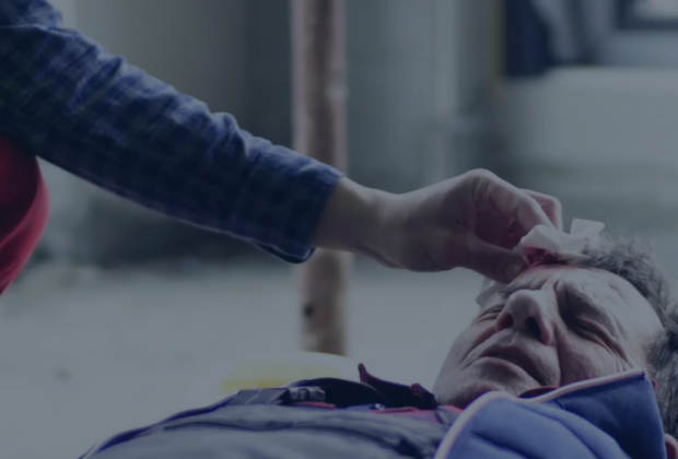 First aid being administered to an injured worker at a jobsite, illustrating incident response and hazard control on a Joint Health and Safety Committee.