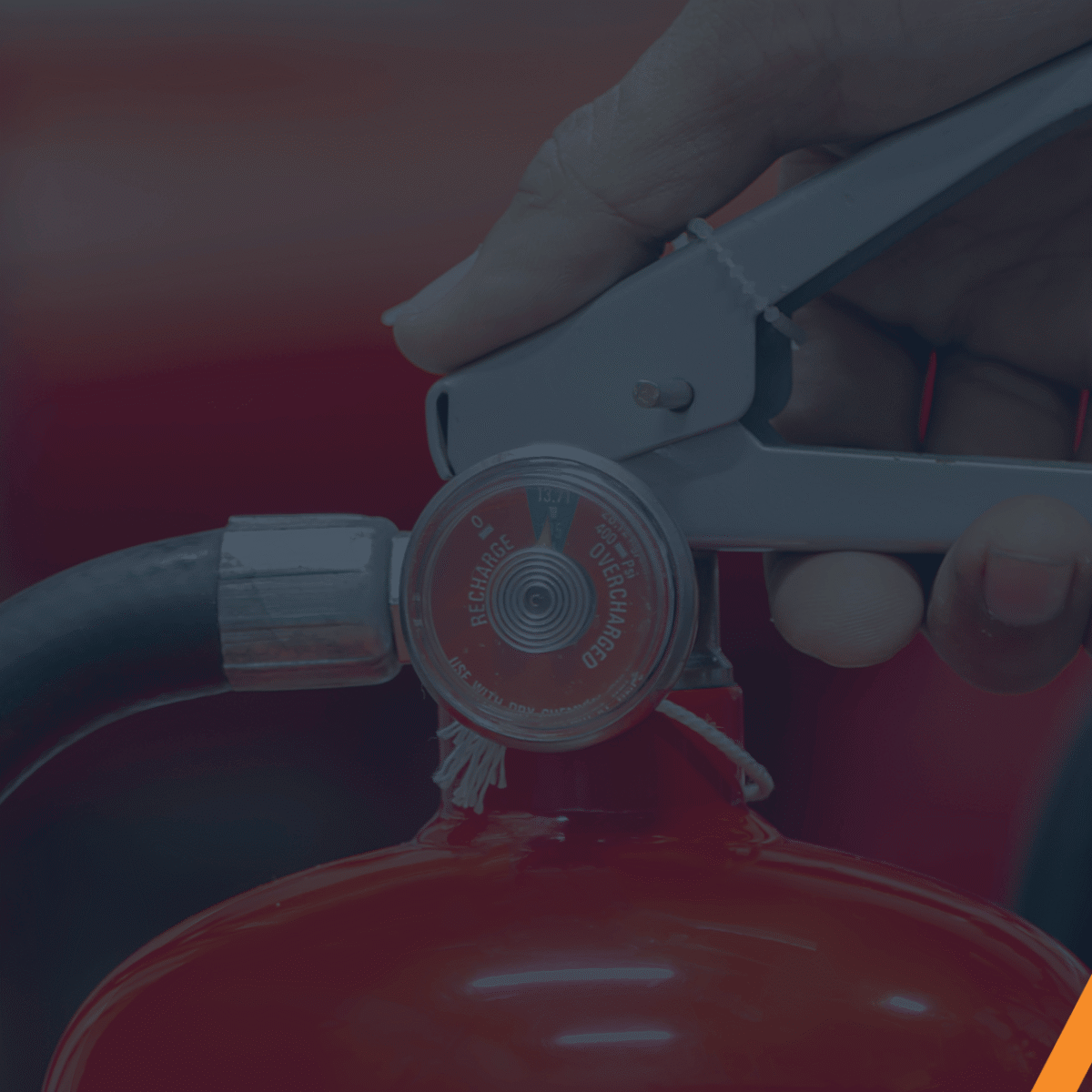 close up of hand holding a fire extinguisher.
